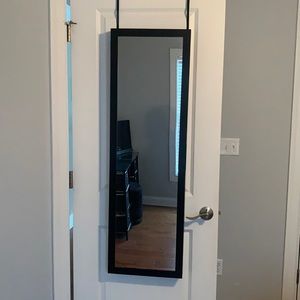 Over the door mirror and jewelry organizer. With 9 hooks and 3 pockets.